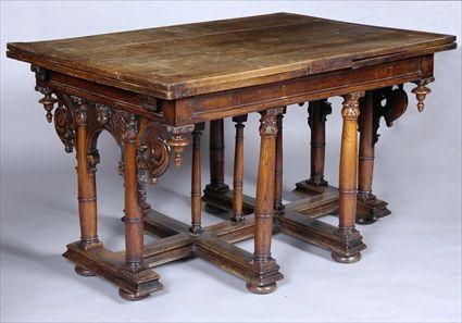 Appraisal: RENAISSANCE CARVED WALNUT DRAW-LEAF TABLE The rectangular top with two