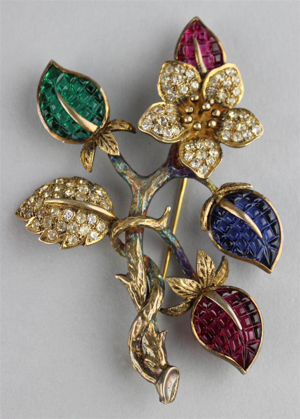 Appraisal: CORO STERLING FLOWER PIN WITH COLORLESS RHINESTONES AND RED BLUE