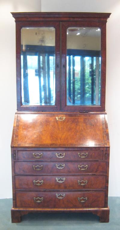 Appraisal: An th Century walnut Bureau Bookcase with pair of bevelled