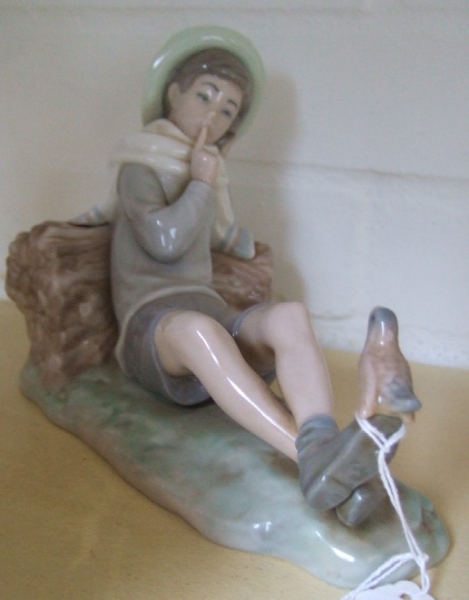 Appraisal: A Lladro figure of a recumbent boy wearing a hat