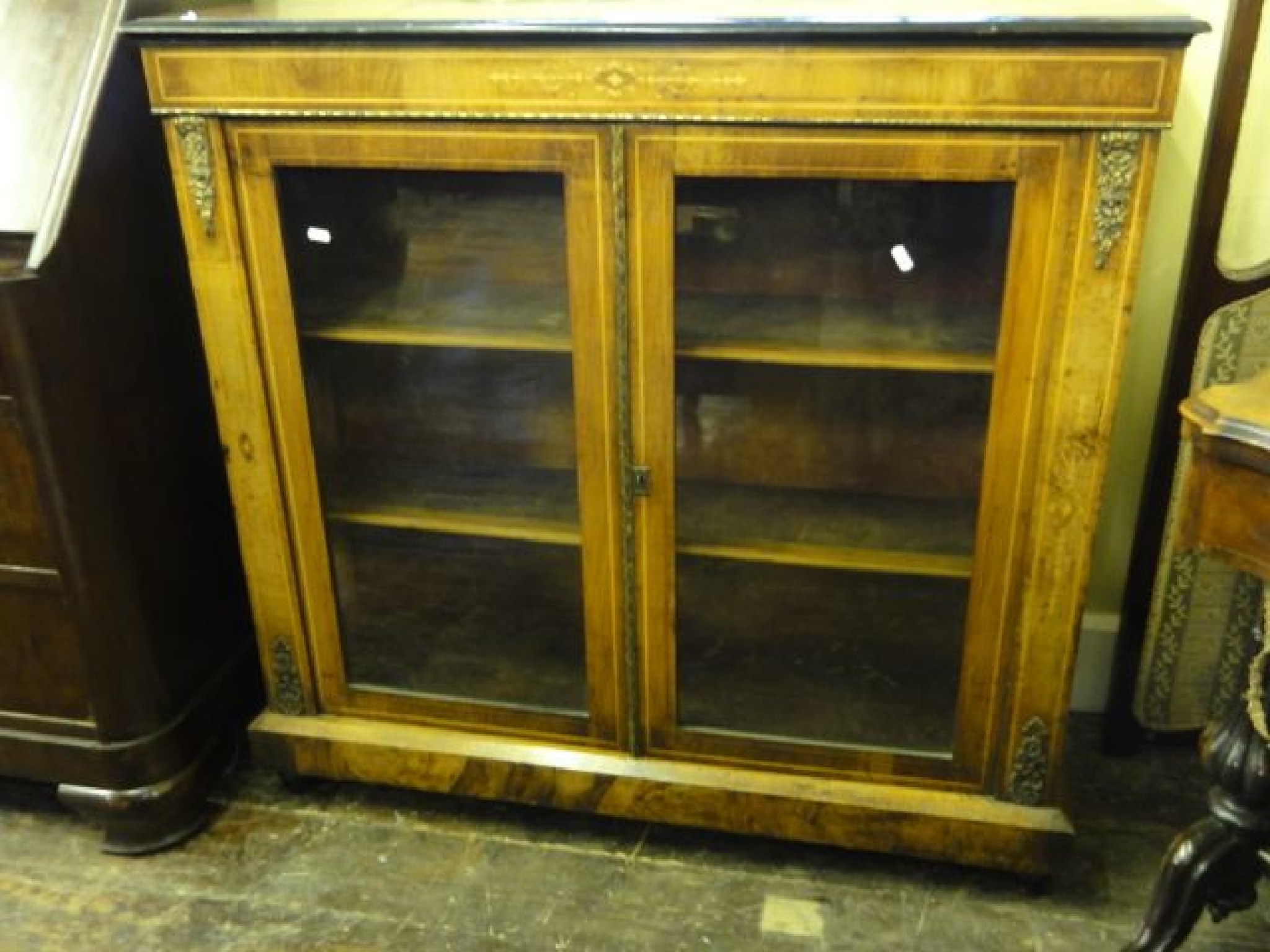 Appraisal: A Victorian walnut pier cabinet enclosed by two glazed panelled