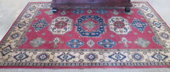 Appraisal: HAND KNOTTED ORIENTAL CARPET Pakistani Caucasian a five geometric medallion