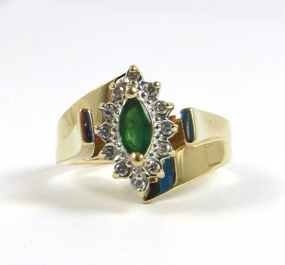 Appraisal: EMERALD AND DIAMOND RING Marquise-cut green emerald Round-cut diamonds K