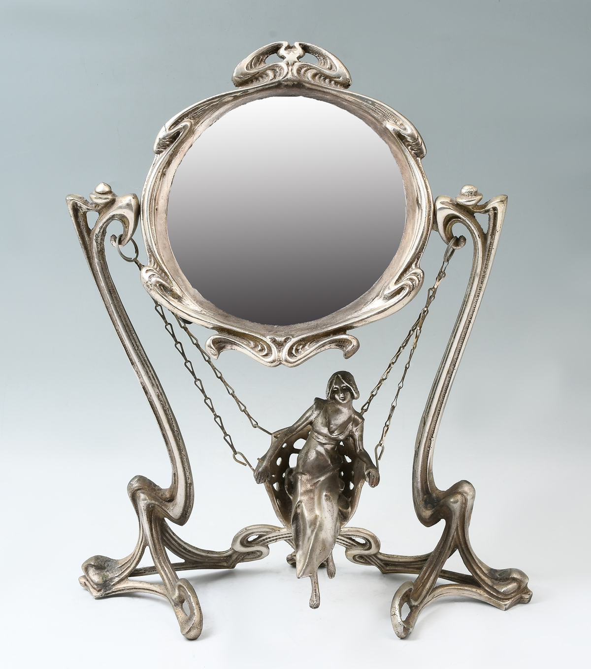 Appraisal: ART NOUVEAU MIRROR WITH FIGURE ON SWING Silvered bronze Art