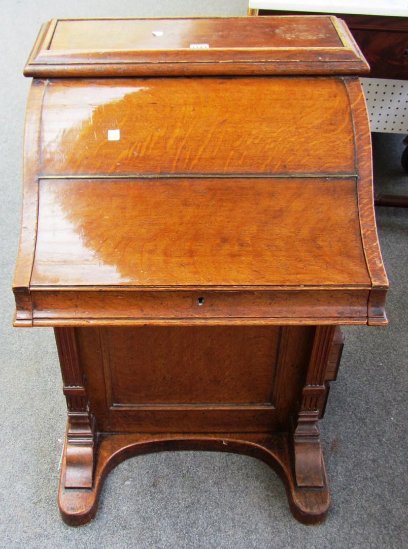 Appraisal: A late Victorian 'piano top' oak Davenport defective pop-up stationery