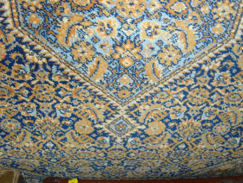 Appraisal: An eastern wool rug with stylised floral decoration in blue