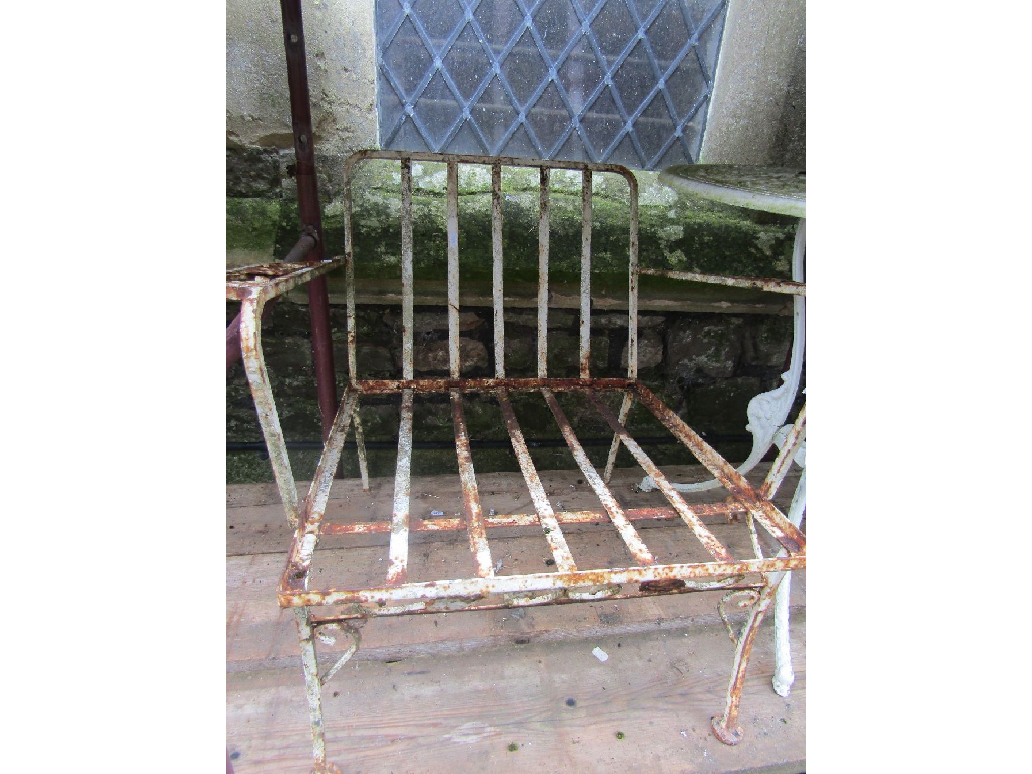 Appraisal: A pair of low painted steel framed garden armchairs with