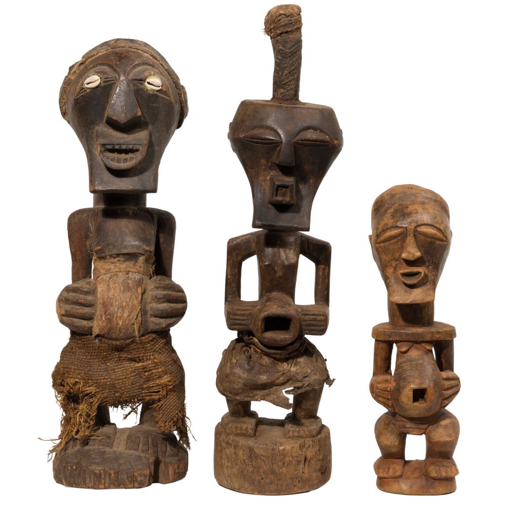 Appraisal: AFRICAN CARVED WOOD FIGURE ASSORTMENT Songye fetish power statues having