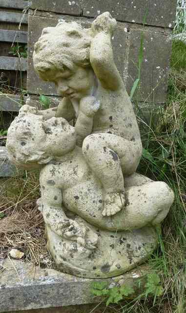 Appraisal: A reconstituted stone figure of fighting putti