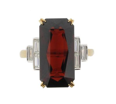 Appraisal: A garnet and diamond ring The long rectangular cut garnet