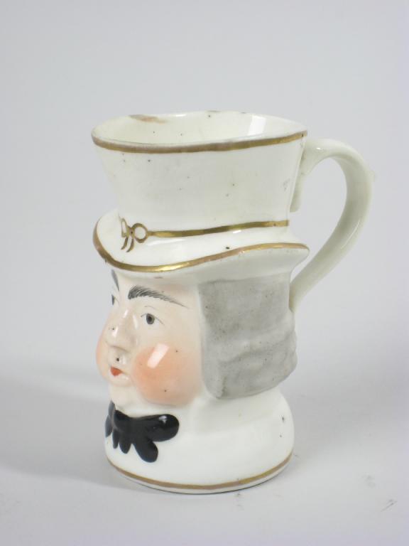 Appraisal: A Staffordshire porcelain Paul Pry Toby Jug with painted details