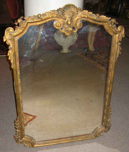 Appraisal: GILTWOOD FRAMED WALL MIRROR The shaped frame carved with shell