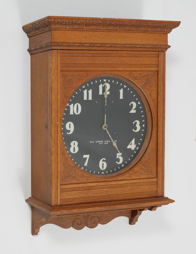 Appraisal: EASTLAKE WESTERN UNION OAK STATION CLOCK Carved oak case with