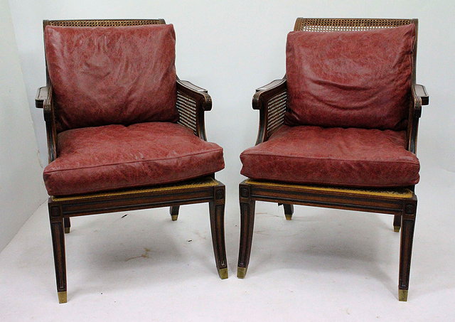 Appraisal: A PAIR OF ANTIQUE BERGERE CANED ARMCHAIRS with red leather