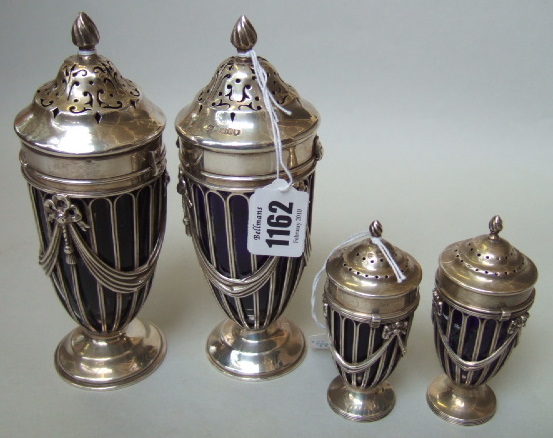 Appraisal: A pair of silver sugar casters and matching pepper casters