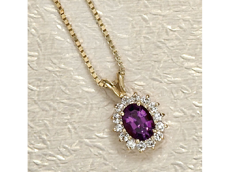 Appraisal: AMETHYST AND DIAMOND PENDANT Yellow gold oval pendant set with