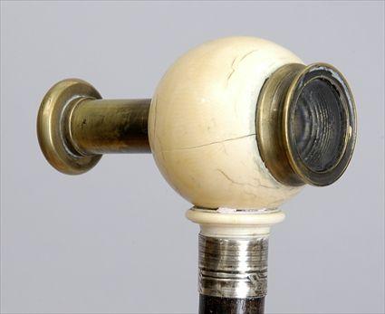 Appraisal: SPY GLASS-HANDLED STAINED WOOD WALKING STICK The spherical ivory handle