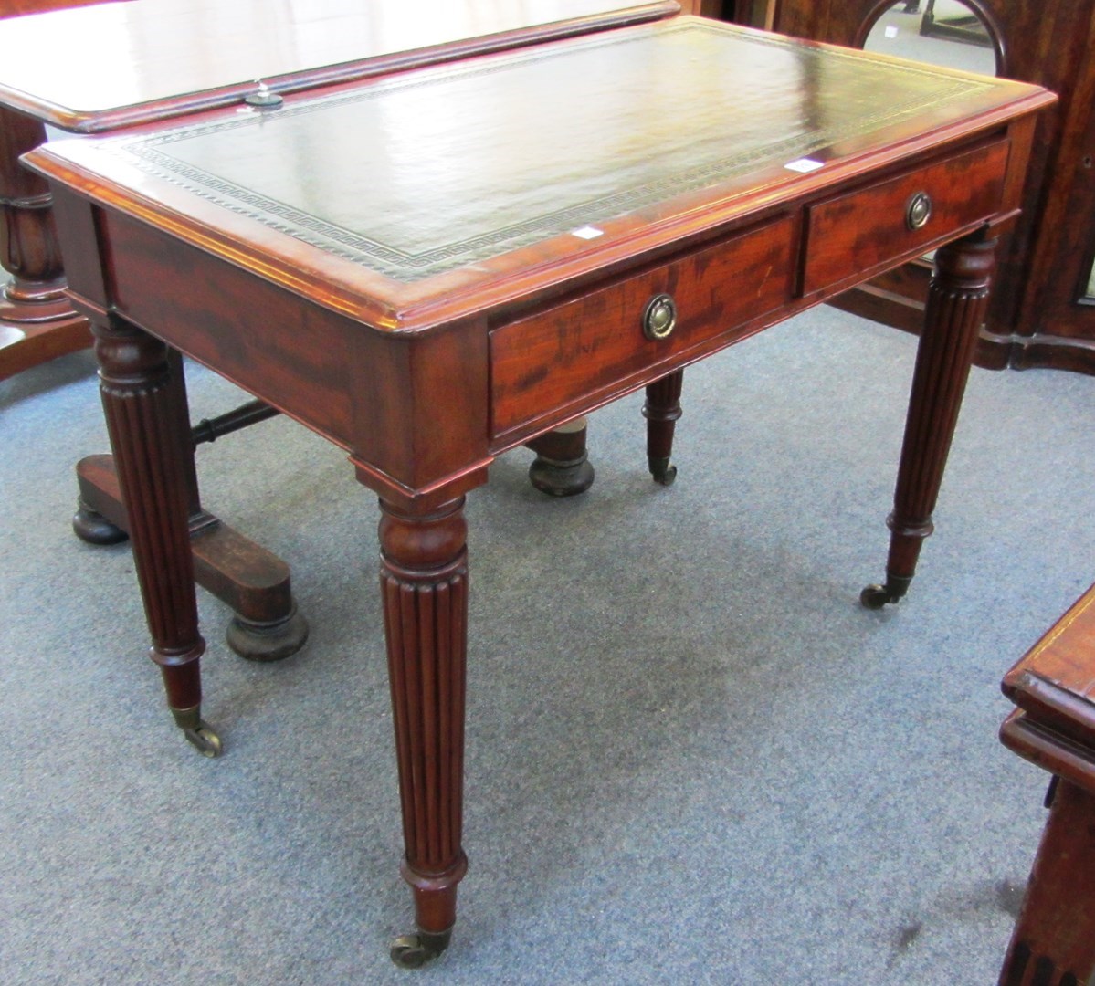 Appraisal: An early th century mahogany two drawer writing table on