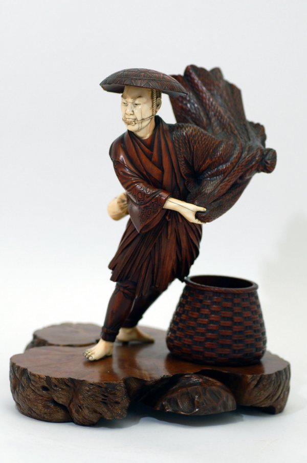 Appraisal: Intricately carved wood figure of a man twirling cape ivory