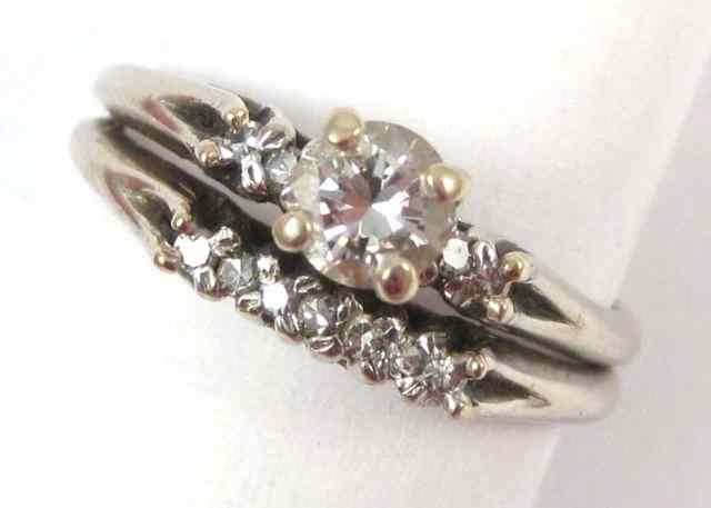 Appraisal: DIAMOND AND WHITE GOLD WEDDING ENSEMBLE the engagement ring features