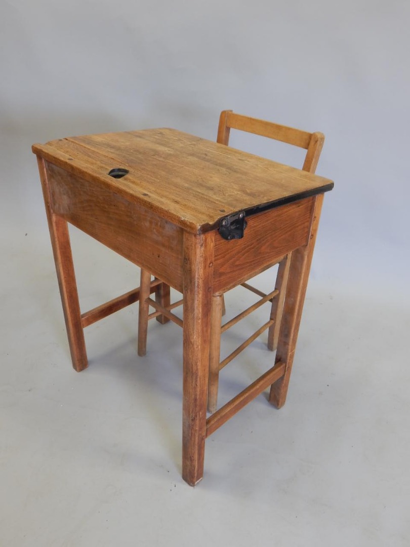 Appraisal: A child's school desk the hinged sloping lid and a