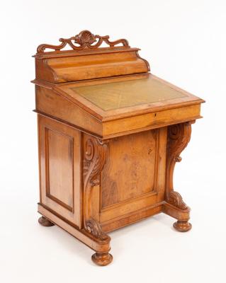 Appraisal: A Victorian oak Davenport with birdseye maple interior on carved