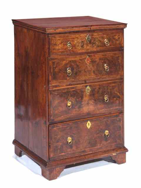 Appraisal: AN ANTIQUE WALNUT AND FEATHER BANDED CHEST of four graduated