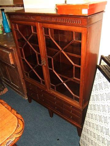 Appraisal: A modern mahogany display cabinet the astragal glazed doors enclosing