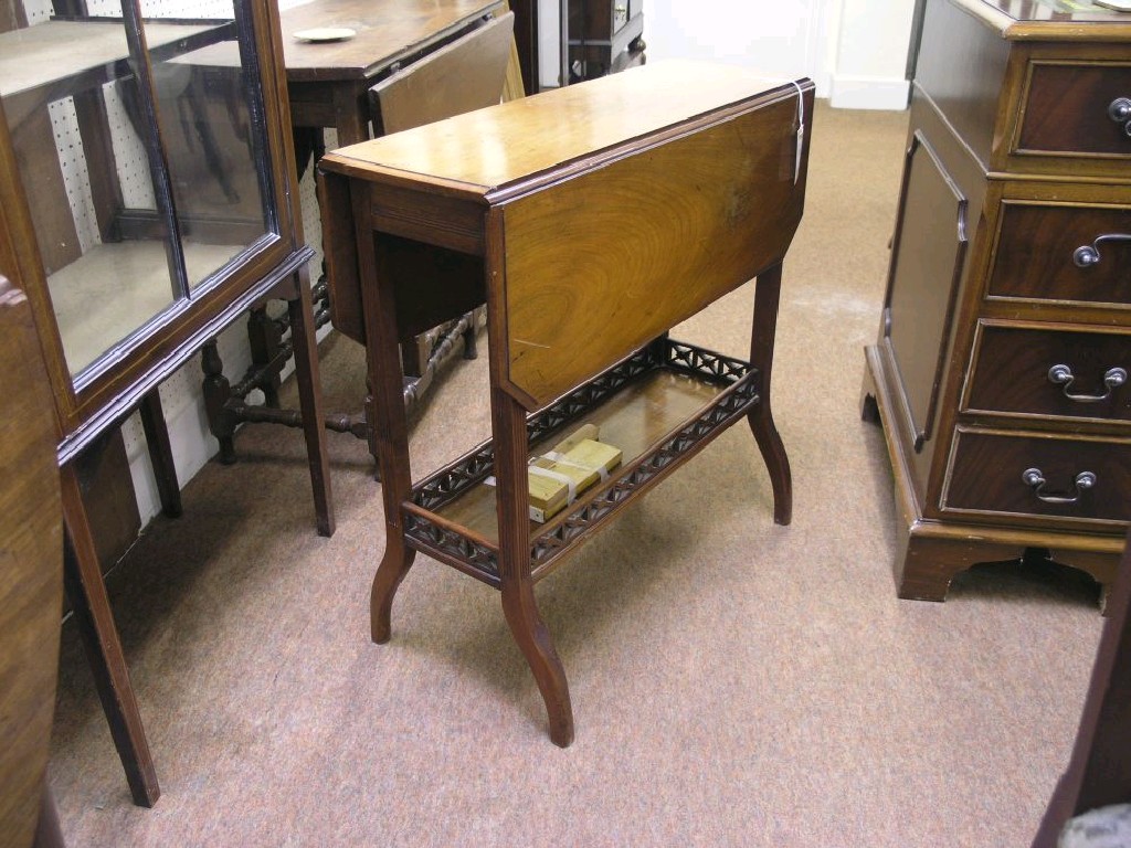 Appraisal: A Victorian walnut Sutherland table on moulded legs with galleried