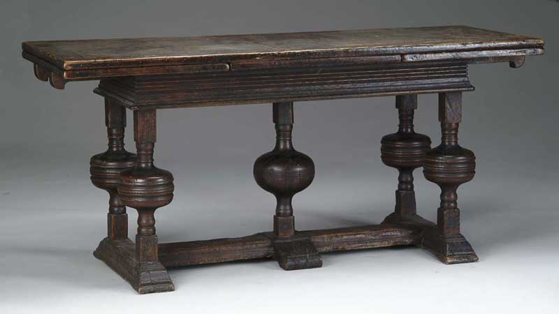 Appraisal: ELIZABETHAN CARVED DRAW TOP TABLE Paneled top has side draw