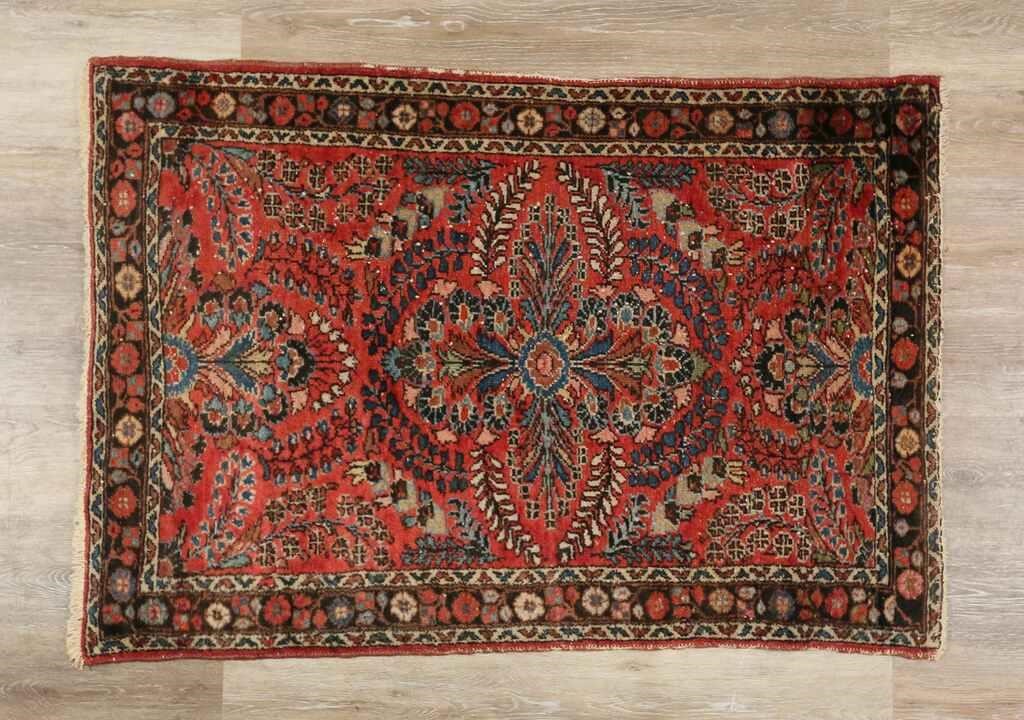 Appraisal: Persian rug Floral motif on red field Fading and discoloration