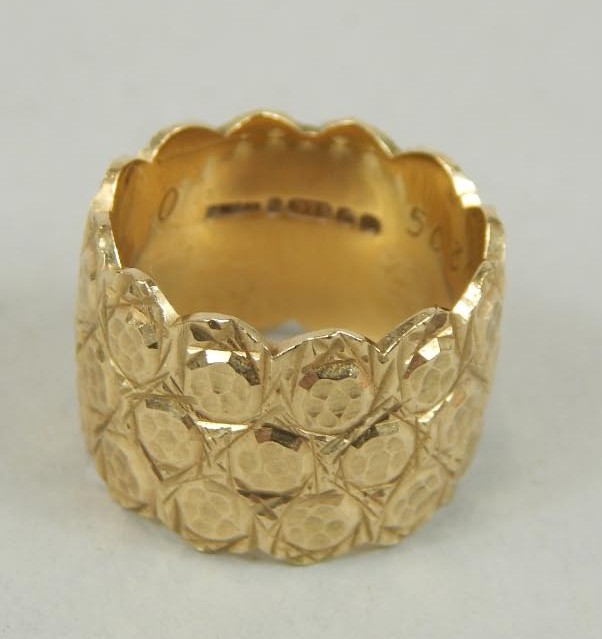 Appraisal: An embossed ct gold wide wedding ring g