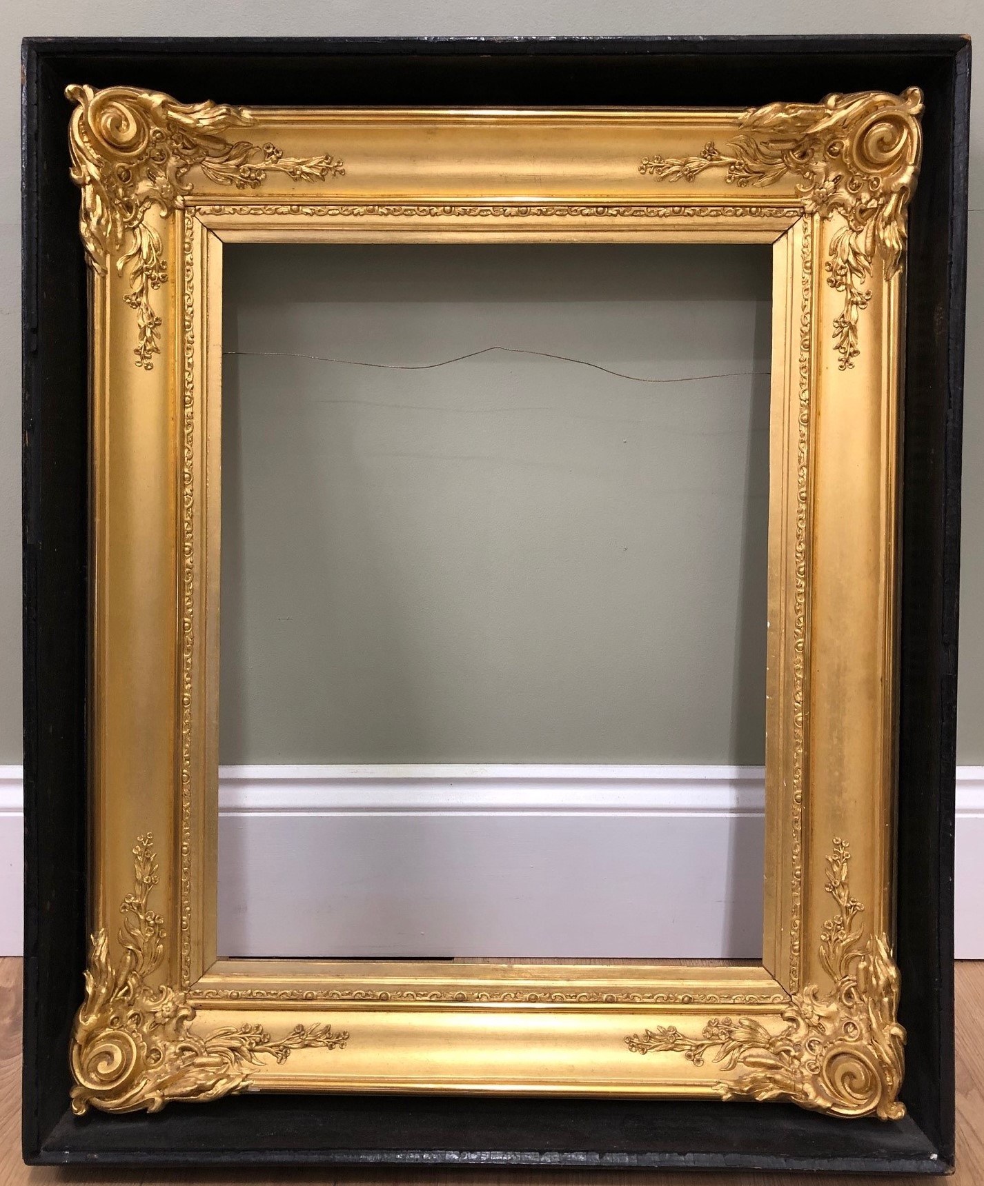 Appraisal: An antique picture frame the black painted outer section with