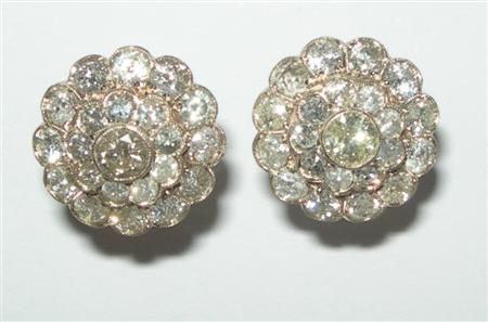 Appraisal: A pair of diamond floral cluster earrings each of shaped