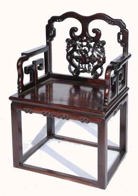 Appraisal: A CHINESE HARDWOOD ARMCHAIR with carved scroll back and arms