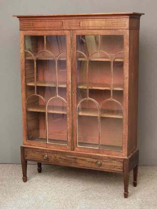 Appraisal: An Edwardian mahogany bookcase on stand the moulded cornice with