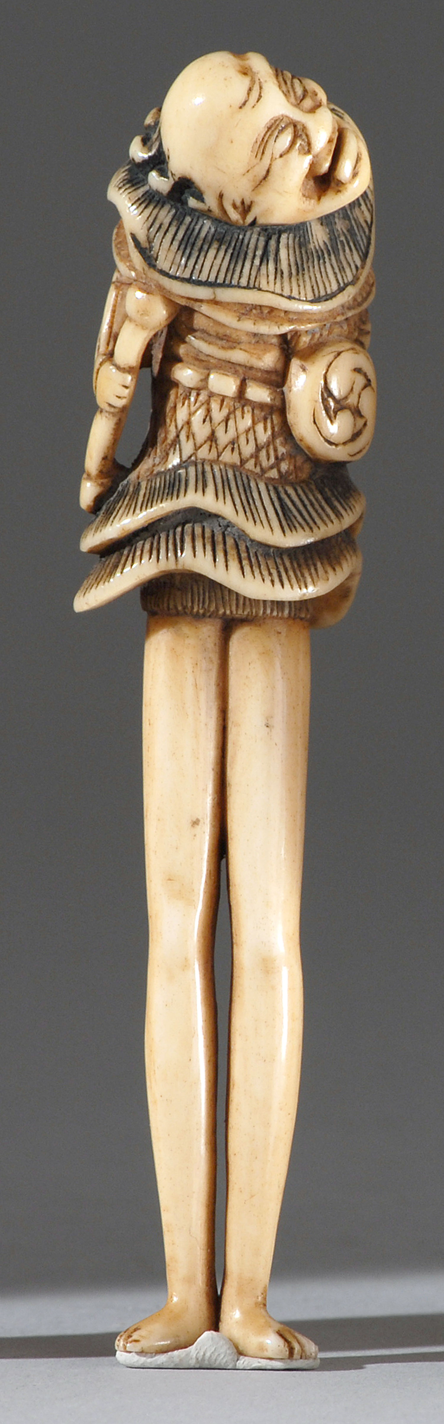 Appraisal: POLYCHROME BONE NETSUKE th CenturyIn the form of a tenaga