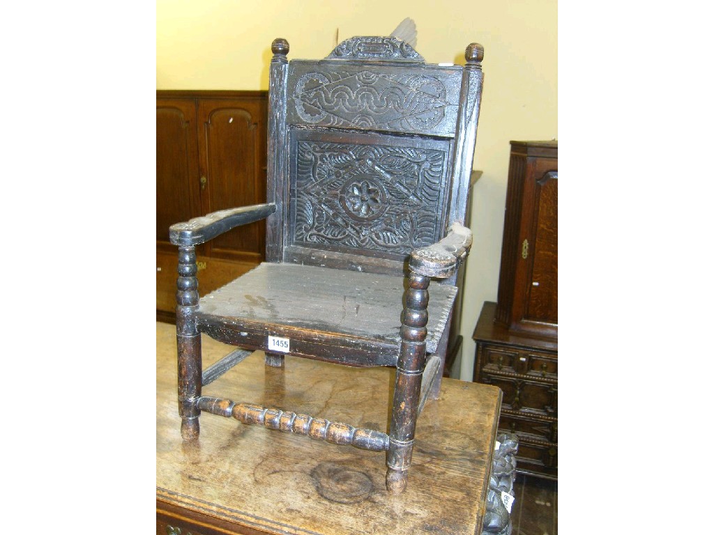 Appraisal: An antique child's chair with carved panelled back over shaped