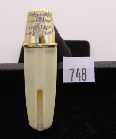 Appraisal: Plastic mending tube with gold tone thimble