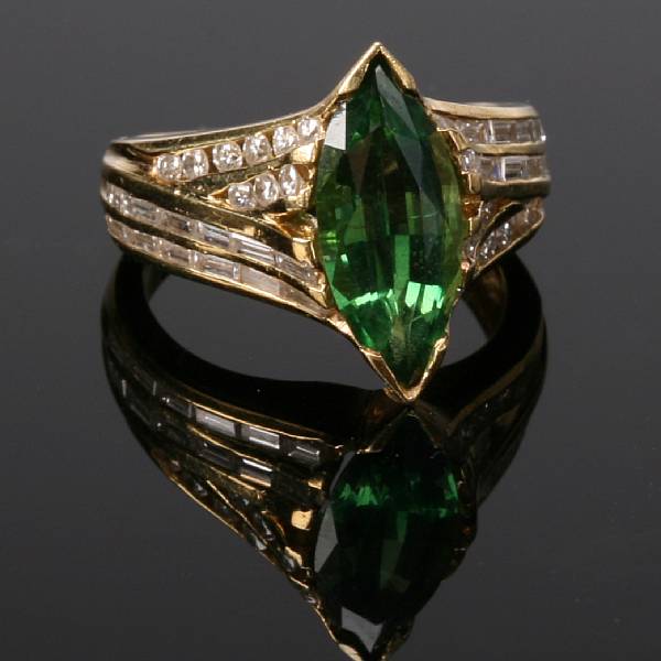 Appraisal: A tsavorite diamond and eighteen karat yellow gold ring centering