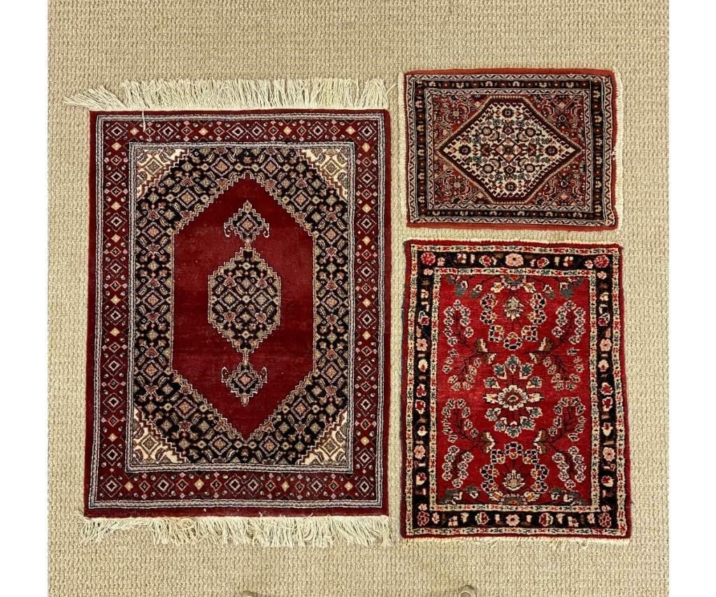 Appraisal: Three Persian mats all with red fields Largest '- x