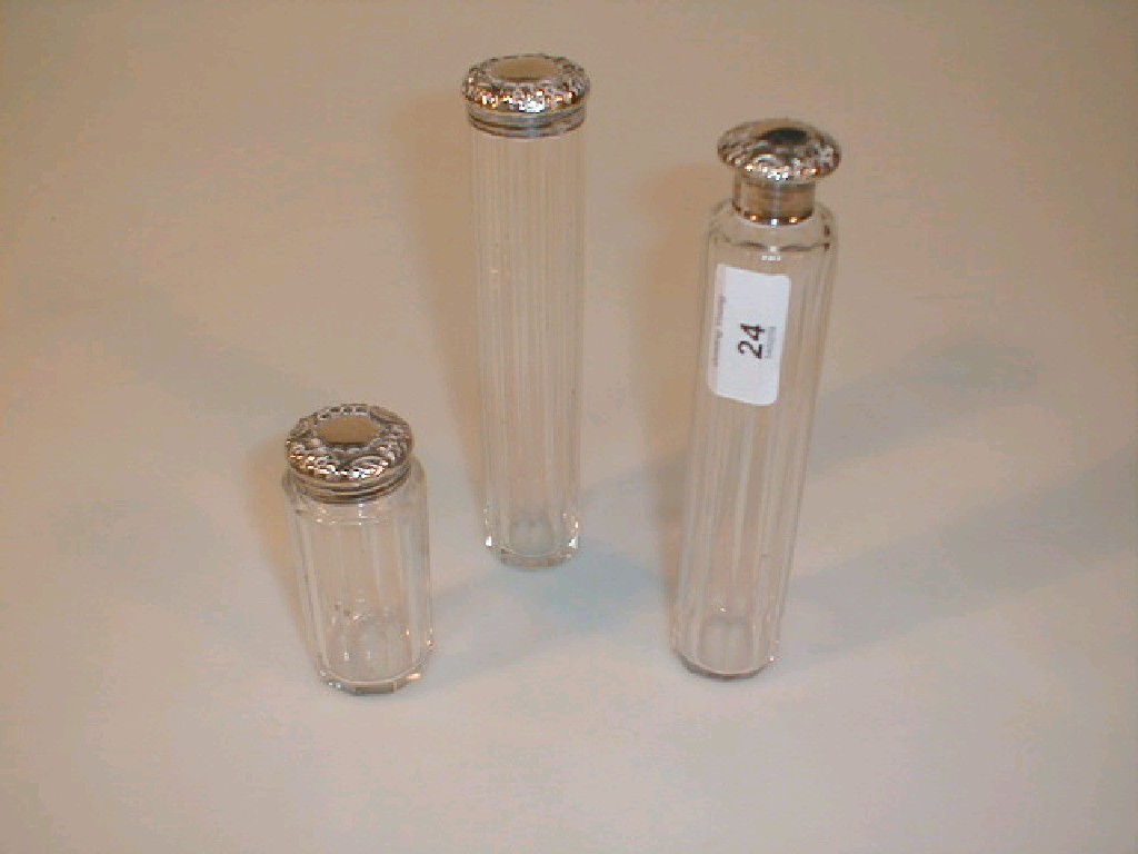 Appraisal: Two Victorian fluted glass dressing table bottles with silver caps