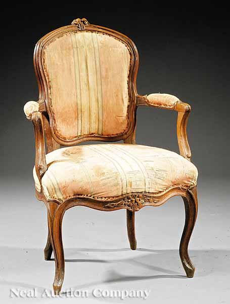 Appraisal: A Louis XV Carved Fruitwood Fauteuil shaped molded back with