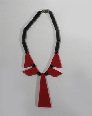 Appraisal: A black and red plastic necklace in the style of