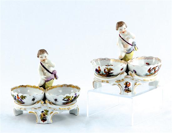 Appraisal: Pair Berlin porcelain figural salts circa winged infant seated above