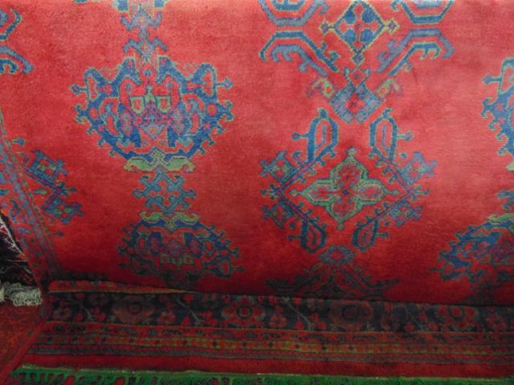 Appraisal: A Turkey wool carpet with red ground field and typical