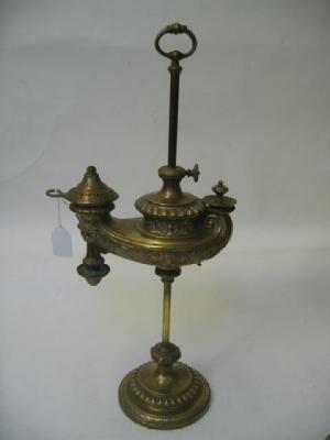 Appraisal: A VICTORIAN BRASS TABLE LAMP modelled as an adjustable antique