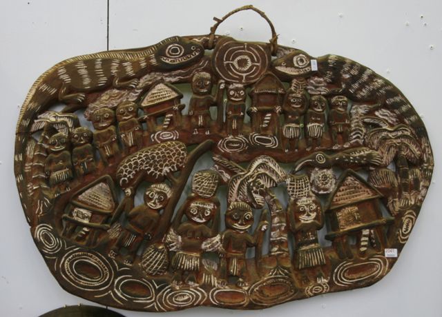 Appraisal: A story board pierced carved wood of a village scene