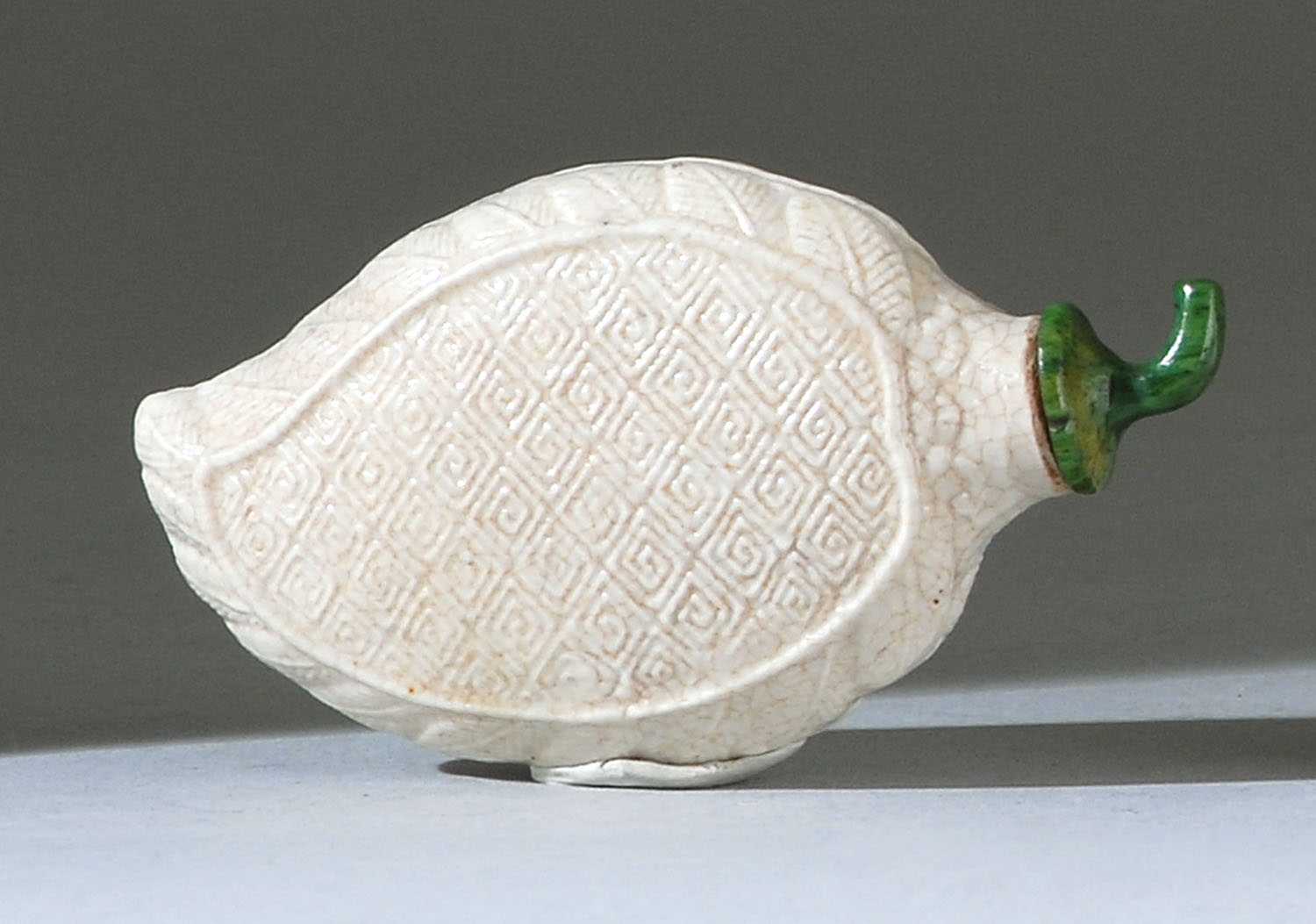 Appraisal: WHITE GLAZE PORCELAIN SNUFF BOTTLE th CenturyIn bow leaf form