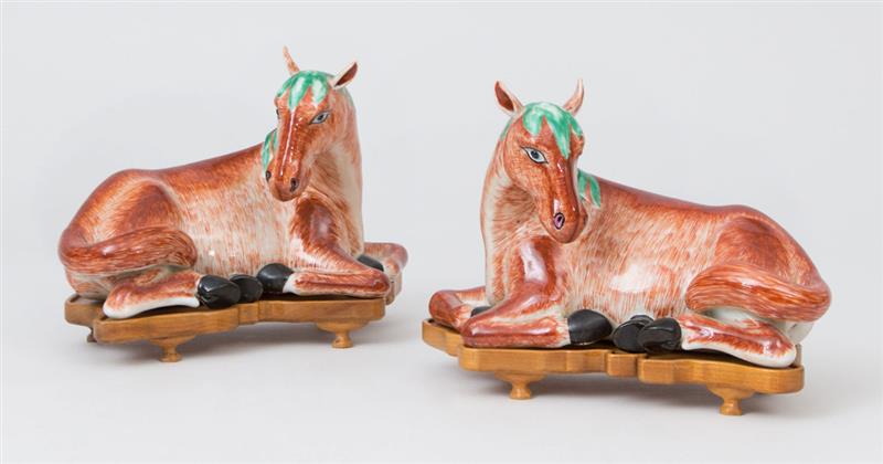 Appraisal: PAIR OF CHINESE EXPORT STYLE IRON RED RECUMBENT HORSES Each